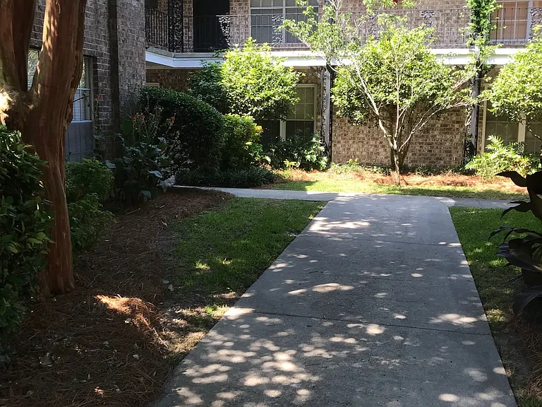 Walking from the designated parking lot towards the condo