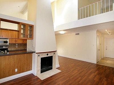 Modern architect designed home with open living/dining area. Skylight over living area lights enteriors during the day. Office space above in alcove.