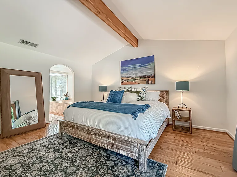Primary bedroom with vaulted ceilings