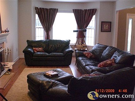 Formal living room with wood flooring and fireplace