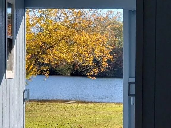 Drive up view through carport.
