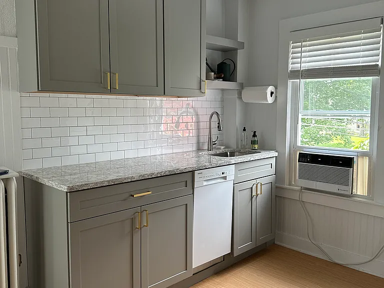 The kitchen was remodeled in 2022. There is an apartment size dishwasher, floating shelves over the sink and a window to keep the space bright.