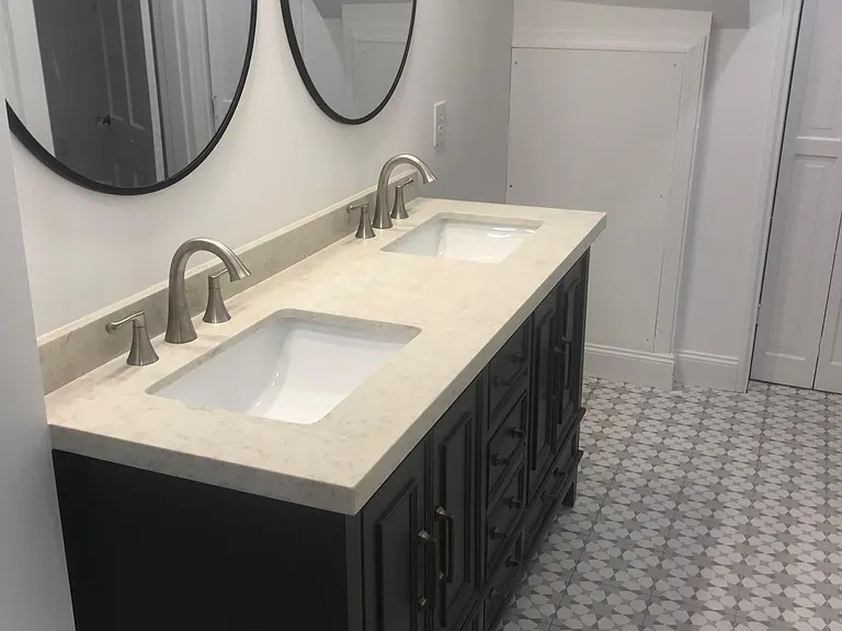 Modern oval matching mirrors and a designer graphic tile for the floor