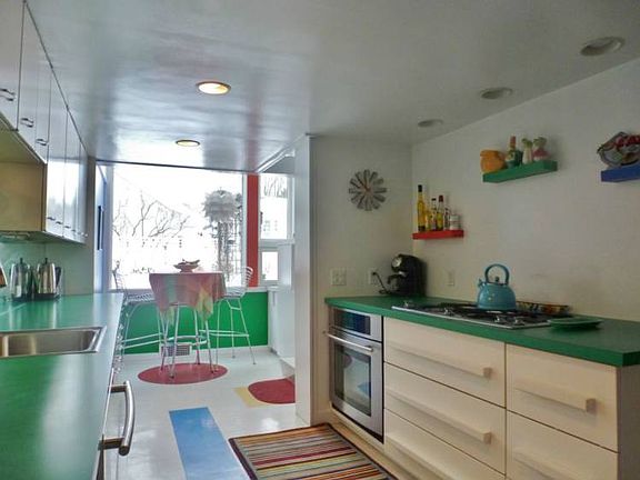 Large galley kitchen with eat-in area and large window that allows the kitchen to bask in the natural lighting. 