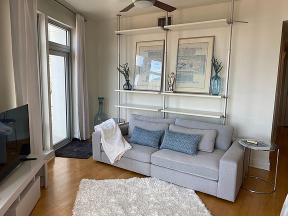 Another view of the living area with a throw rug.