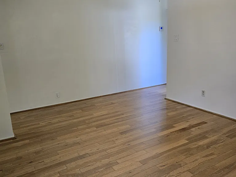 This view is from the kitchen over looking the dining room. To the right you will go to the restroom, 2 bedrooms, hall storage and private tiled garage and laundry area