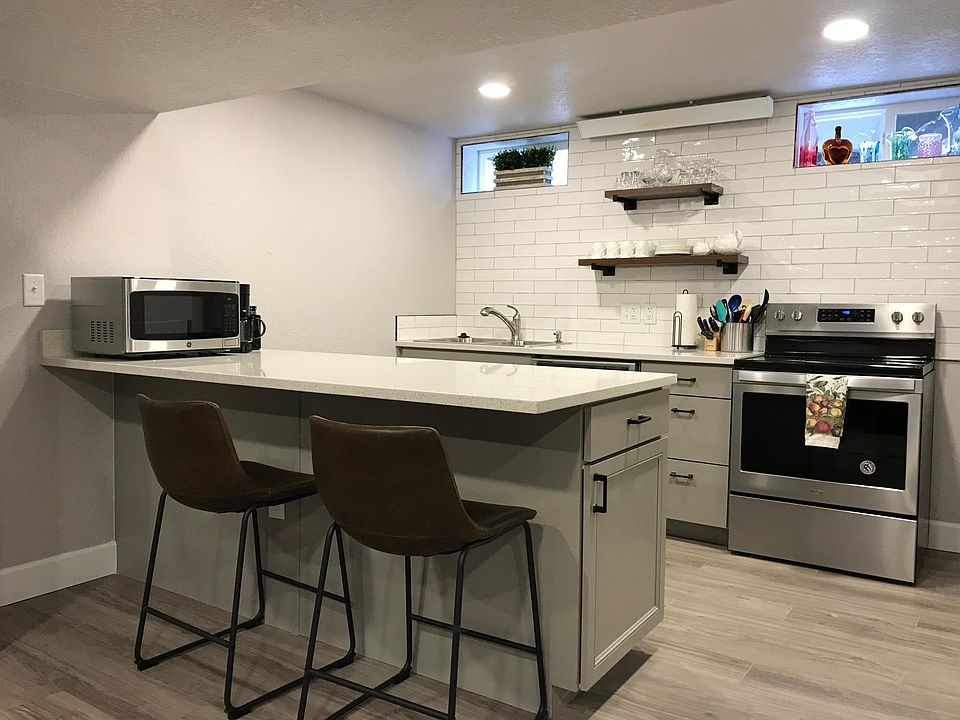 Quartz counters and energy efficient appliances including dishwasher, garbage disposal, electric range and fridge. The kitchen is fully stocked and ready for your groceries.