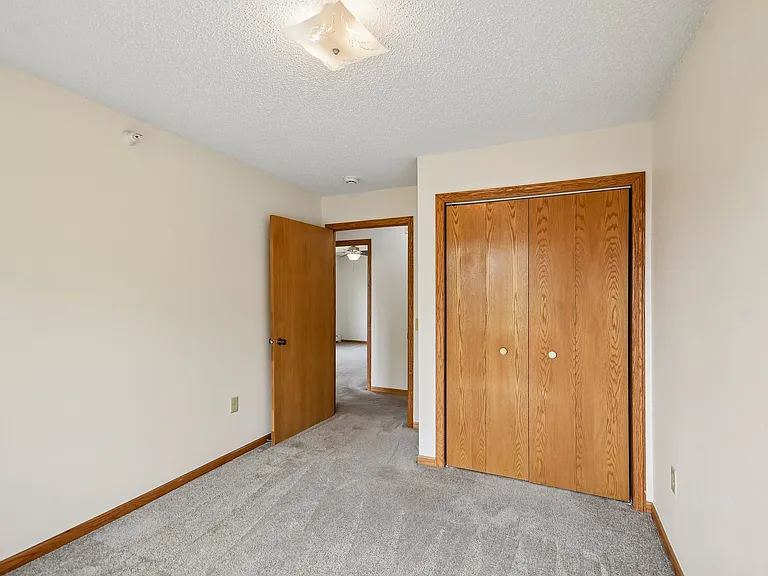 Step inside Mill Pond Apartments, where comfort meets style. This spacious bedroom features plush carpeting, plenty of natural light, and ample storage with custom closets. Perfect for your personal retreat. Schedule a tour today!