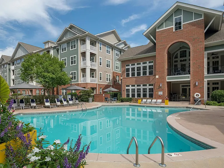 Resort-style pool with modern clubhouse, sundeck, and lounge seatingupscale apartment living in Charlotte.