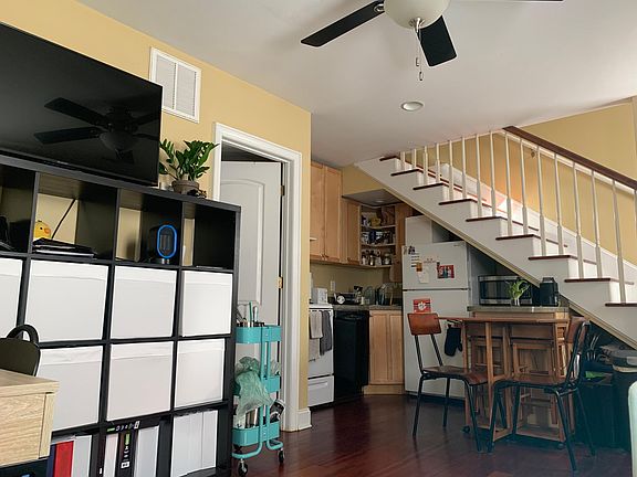 *Old photo - Unit is now a light grey. View from living rm of kitchen and stairs leading to 2nd floor bedroom, full bath, w/d,