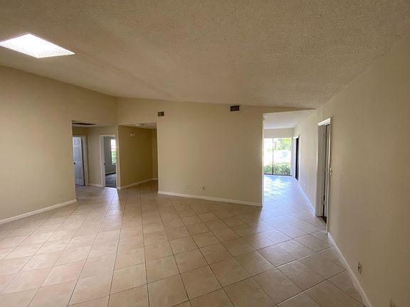 Main room with skylight, entrance to kitchen on right, foyer to the left, front bedroom and bath to the far left, master bedroom access on far right