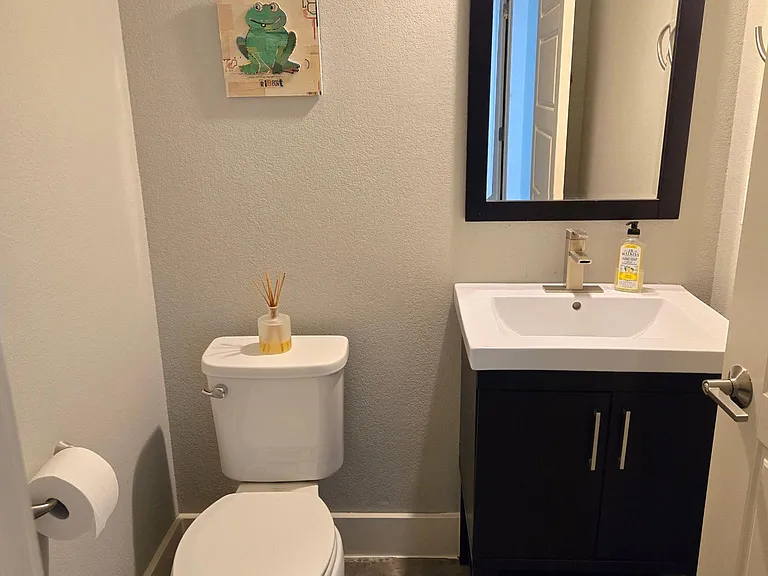 Downstairs half bath for guests near the laundry room