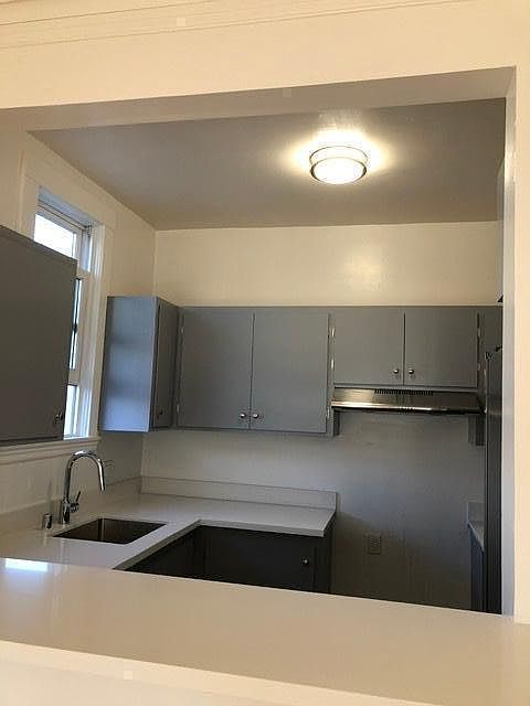 Kitchen with window. New white granite counter with eating bar top.