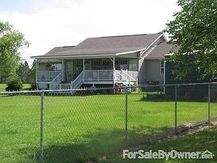 Rear of Home
						:
						Covered back porch facing pond and 5' high chain link fence with 4 gates.
