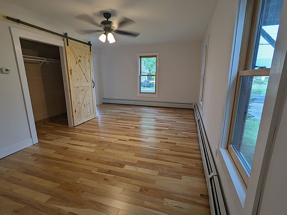 Living room with large closet, located on the first floor.