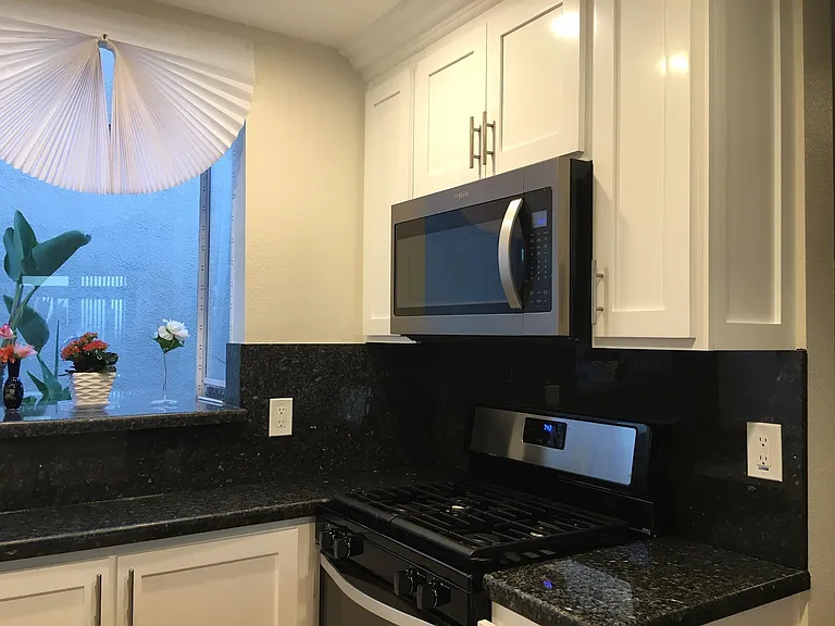 View of COURTyard and Ocean waves seen from this remodelled OCEAN FRONT kitchen.