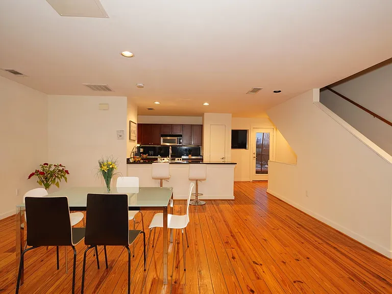 Dining area and kitchen on the 2nd floor with stairs going up to the main bedroom