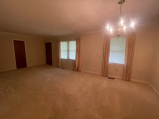Front entrance into living room with dining area