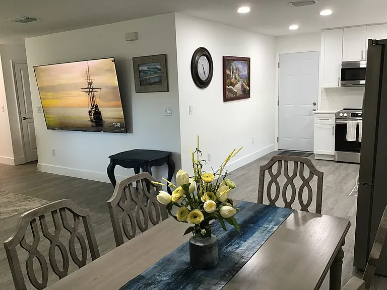 An inviting gathering space with open-concept living and dining designed for comfortable table seating.