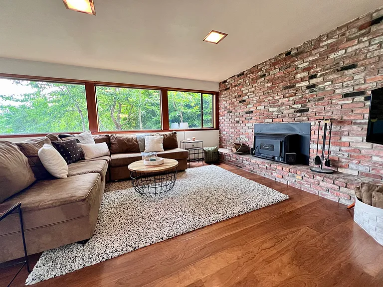 This wood-burning insert provides great heat in the winter. A wonderful space to cozy up and watch a movie.