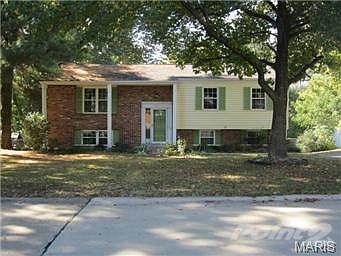 Curb Appeal is not lacking here!  Lovely setting in the trees!