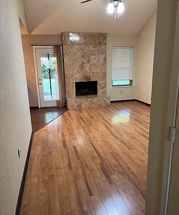 Living room with high ceiling, elegant marble fire place and Brazilian cherry hardwood.