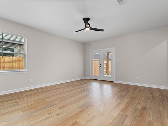The kitchen and dining room feature a view of the backyard.