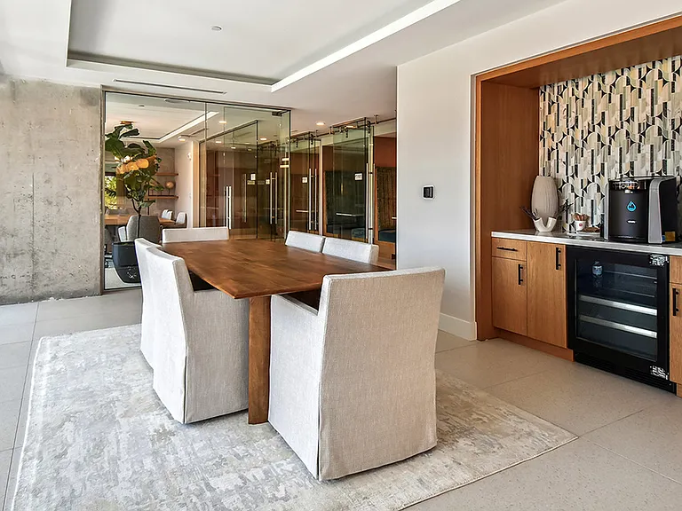 Griffis West Palm apartment coworking lounge with coffee machine and dining table.
