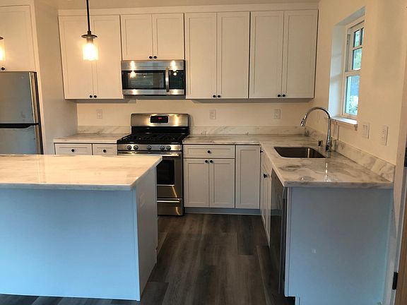 Kitchenwith quartzite counter tops. Also has sky light.