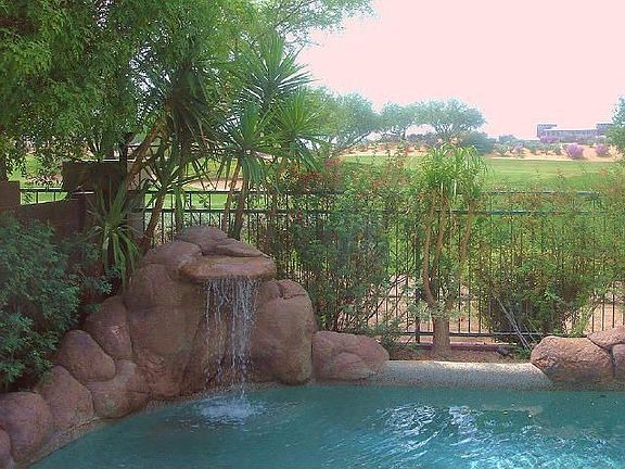 Lush waterfall pool with heated SPA