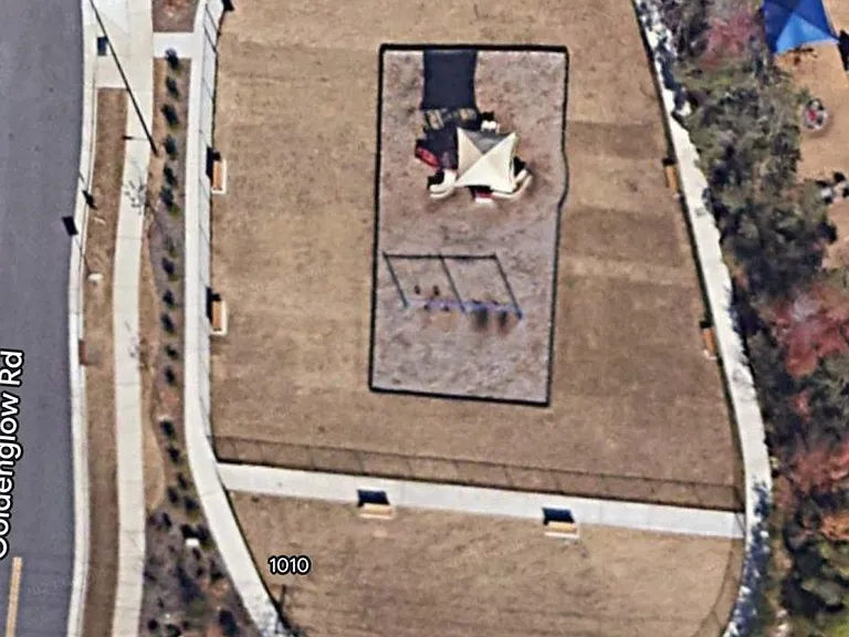An aerial view of the playground and bark park enclosure from google maps.