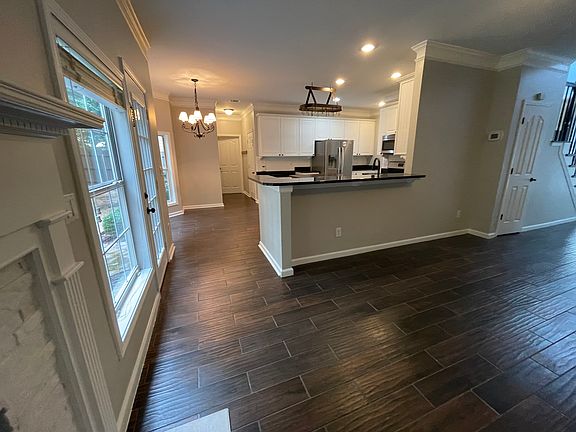 Bar-height countertop connects kitchen to living room _ great for hosting or quick meals.