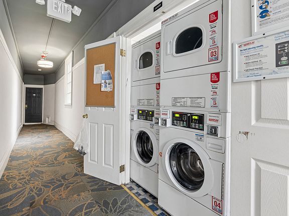 Laundry room with washing machines neatly arranged on a wooden floor