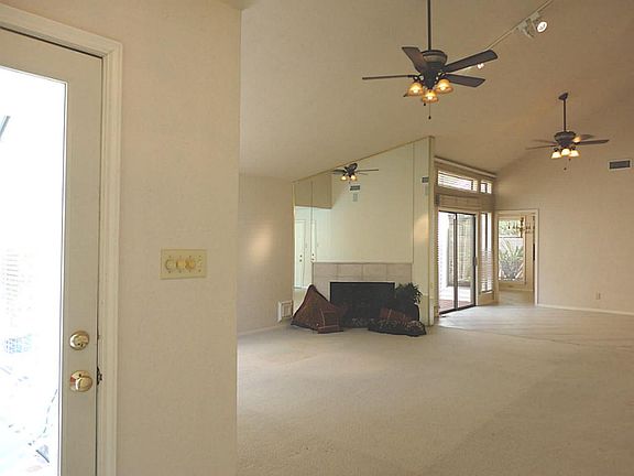 Dramatic view of living and dining areas from front door - open floor plan, high ceiling and walls of windows!