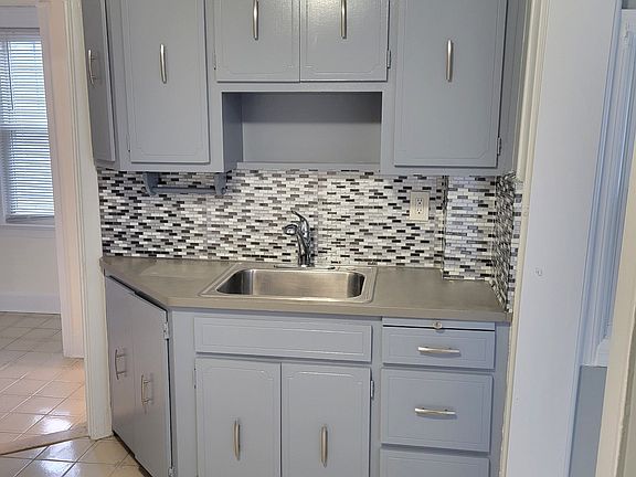 Kitchenette with sink counter & cabinets