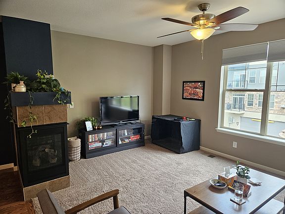 Living area with 3-sided fireplace on the left
