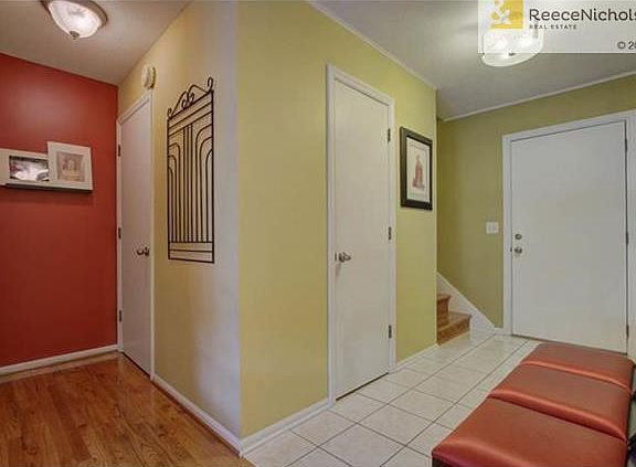 Half bath is located off the entry. Hall way features large coat closet as well as access to the lower level.