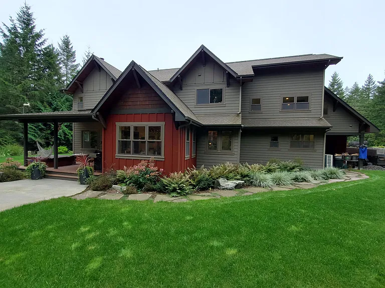 The home has mature, beautiful landscaping on all sides, and a large irrigated yard for outdoor activities.
