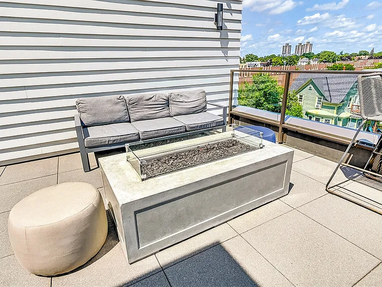 Unwind by the fire, soak up the sunshine, and enjoy rooftop living from our cozy outdoor lounge.
