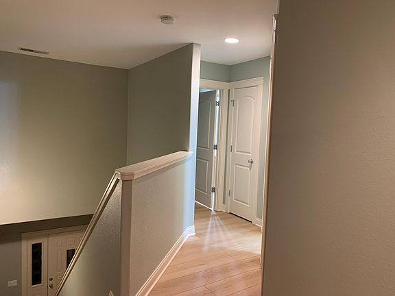 Upstairs hallway with new flooring and linen closet.