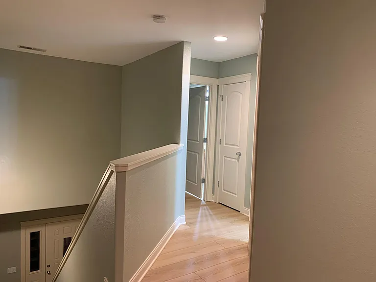Upstairs hallway with new flooring and linen closet.