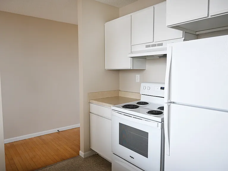 Kitchen with white appliances at Rosewater.