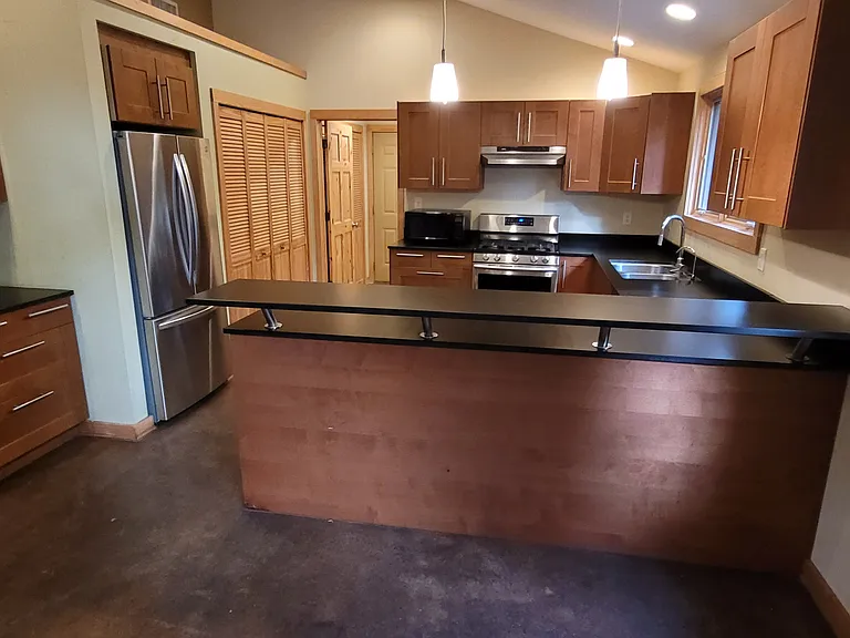 This kitchen is spacious and easy to cook in. The high countertop works with tall chairs as a breakfast area or bar.