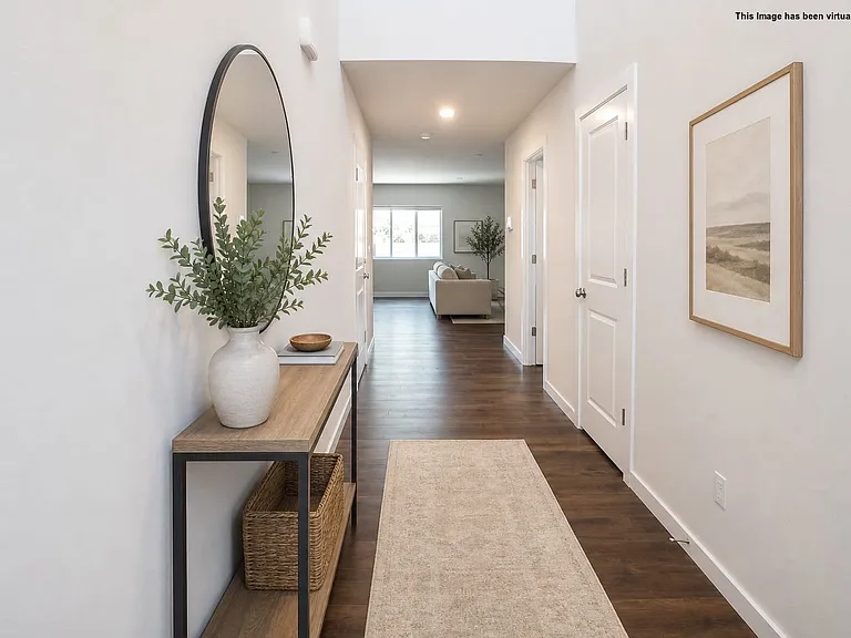 Welcoming hallway, coat closet on the right, virtually staged.