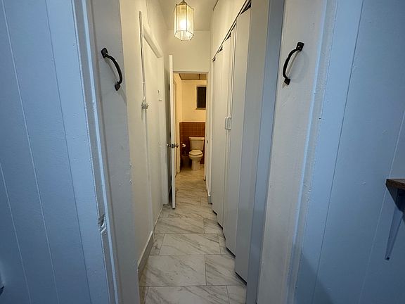 Bathroom hallway with closet on the right.