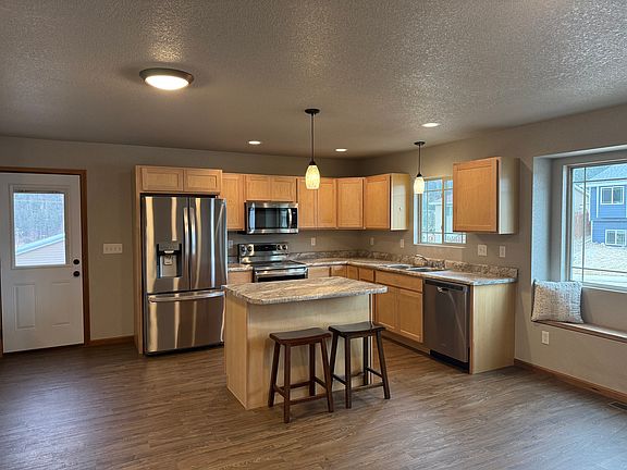 Great room - kitchen. Side door leads out to back yard.