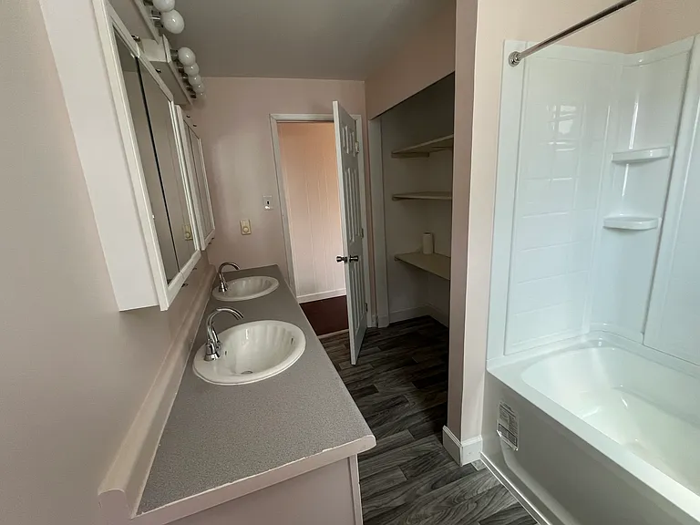 Full bathroom with shower, tub, and 2 sinks