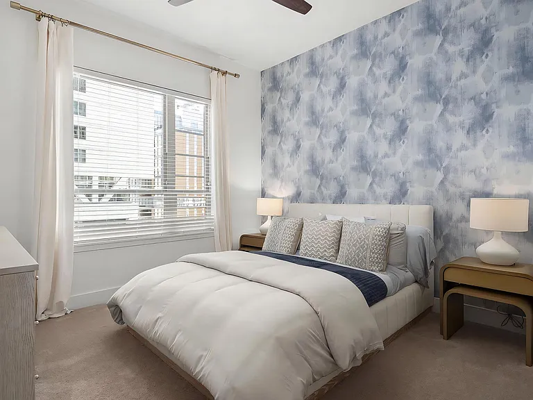 Spacious Bedroom with King Bed, Dark Accent Wall, and Elegant Lighting