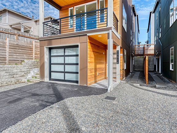 The covered entrance is adorned with cedar paneling and knotty pine ceiling with recessed light as you enter through a frosted glass paned door. Convenient 2-car tandem garage with additional driveway parking.