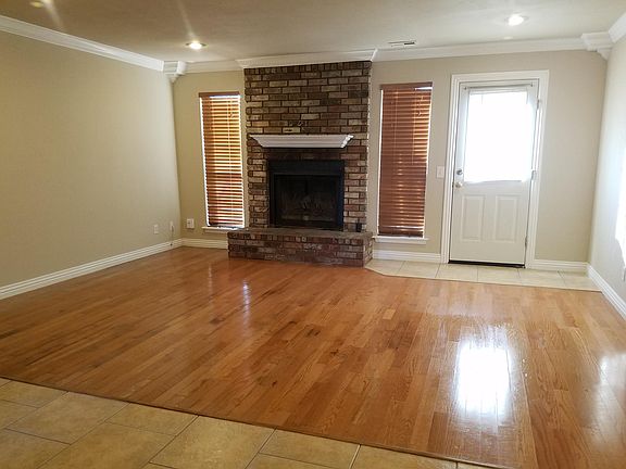 Real wood burning fireplace, real wood flooring and wood blinds throughout. Rear door exits onto your own deck and fenced yard. Mostly Energy efficient bulbs are either LED or florescent. Crown molding throughout.